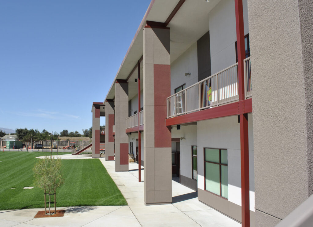 Exterior shot of the Greenfield High School modular classroom building showing the architectural layout and outdoor access to classrooms.