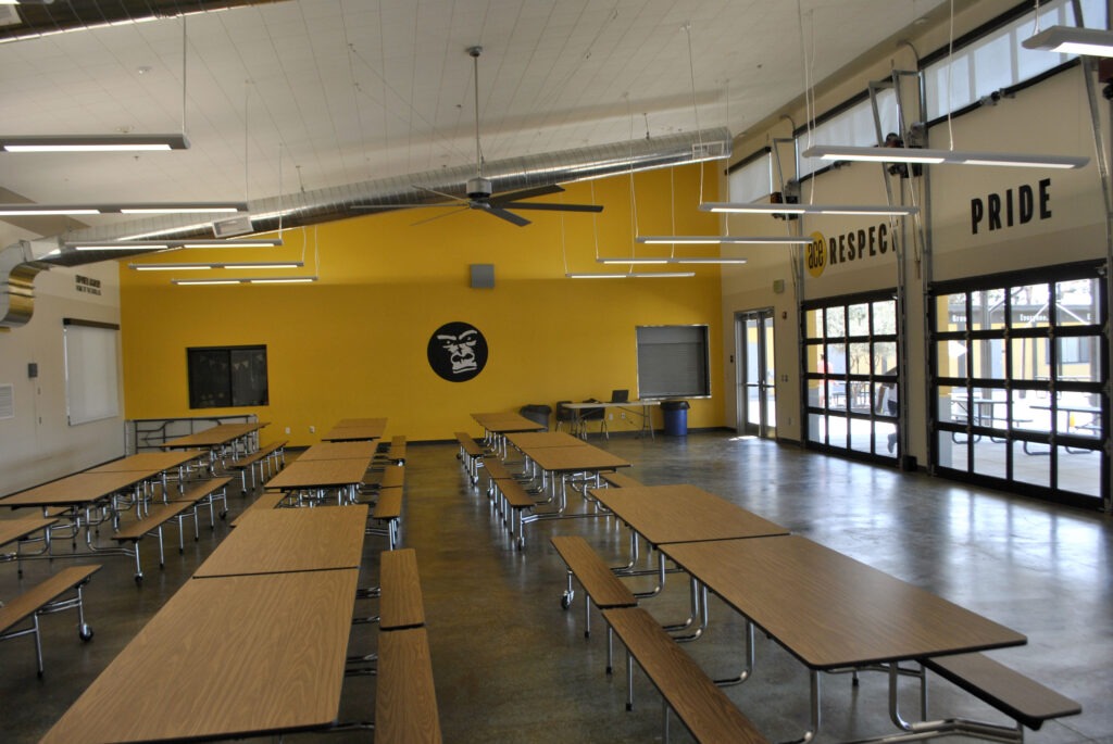 Cafeteria area inside the ACE Empower Academy multipurpose building, featuring ample space for various activities.