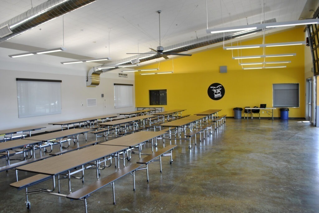 Wide view of the multipurpose building at ACE Empower Academy, showcasing the spacious seating area.