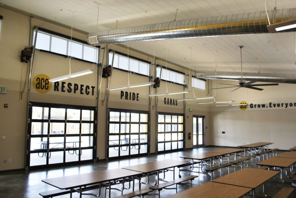 Natural light streaming into the ACE Empower Academy multipurpose building through Solatubes and clerestory windows.