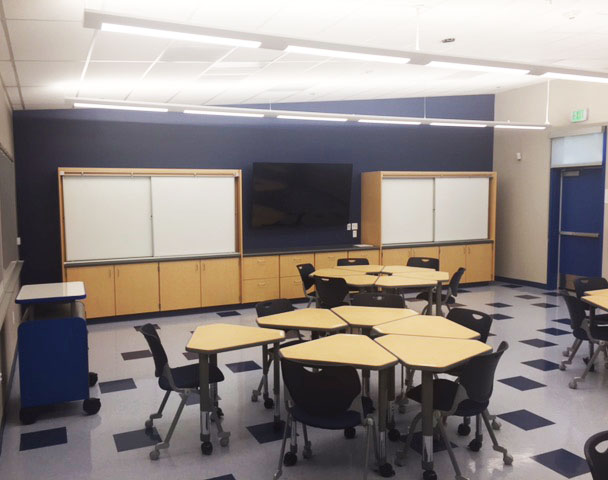 Classroom inside Alhambra High School's modular school building with modern furniture and LED TV.