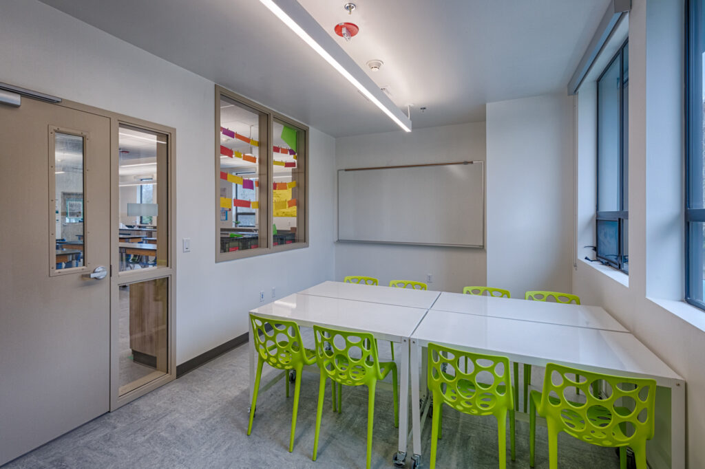 Bright and modern study room at Davidson Middle School science building with green chairs and a collaborative learning space.