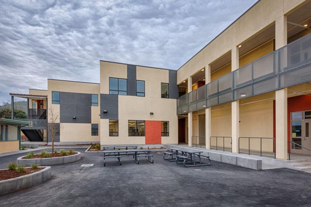 Rear courtyard of the Davidson Middle School modular science building, showing outdoor seating and a modern, two-story design.