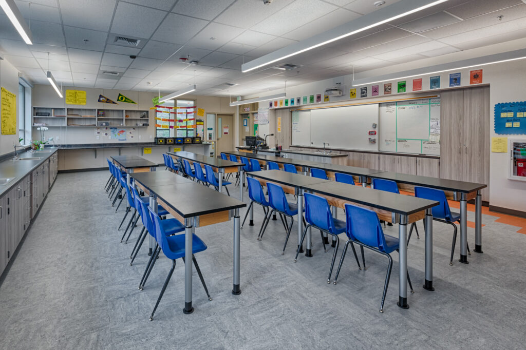 Well-lit classroom in the Davidson Middle School modular science building with blue chairs and a modern teaching setup.