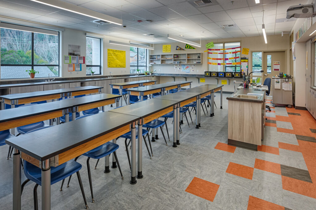 Interior of a second science lab at Davidson Middle School, featuring modern lab tables, storage cabinets, and colorful flooring.