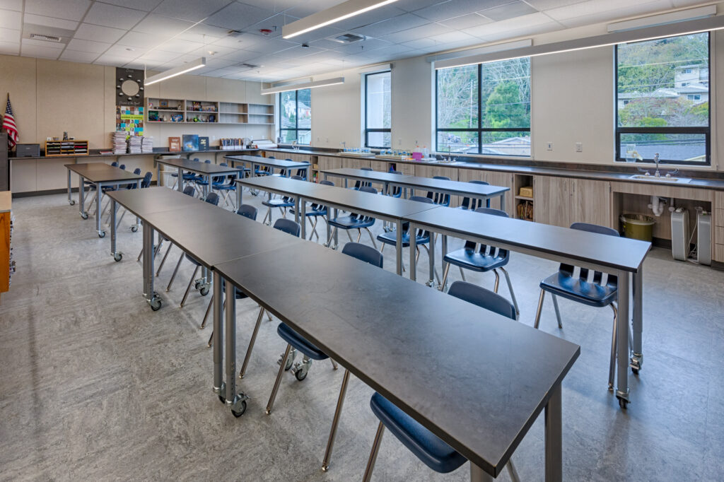 Interior of a science classroom at Davidson Middle School featuring long lab tables and large windows for natural light.