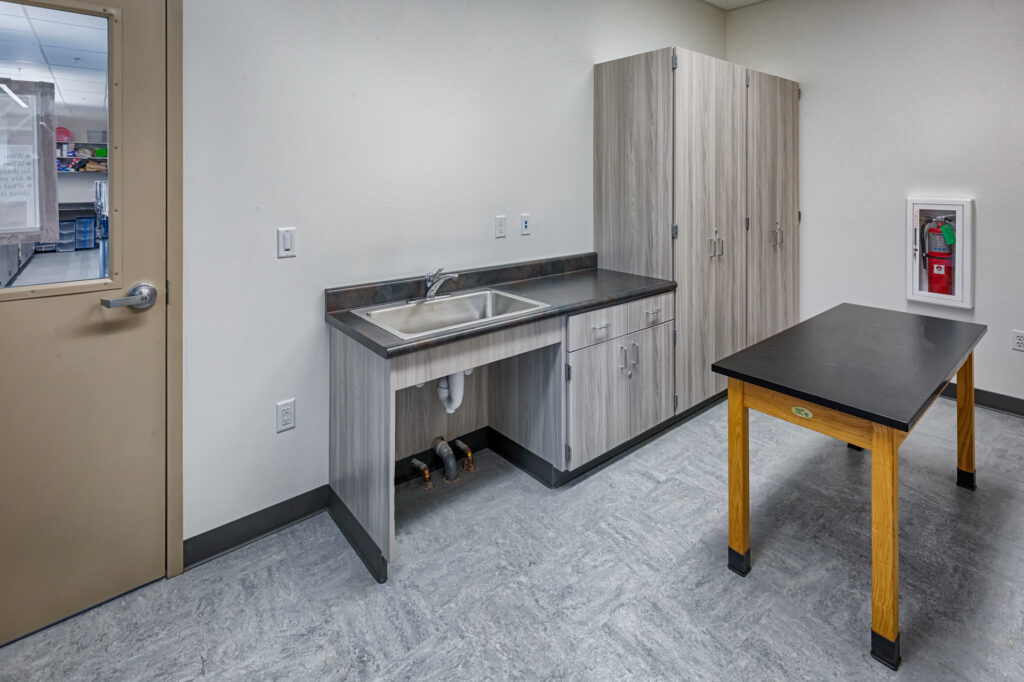 Lab sink area and storage in a science prep room at Davidson Middle School’s modular science building.