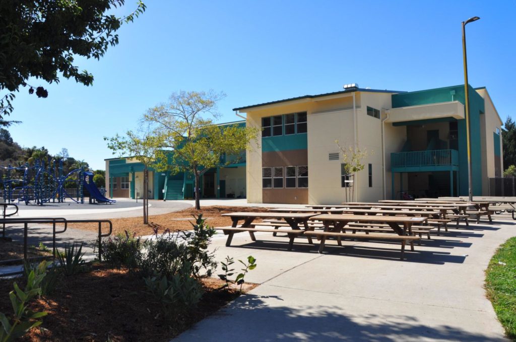 Outdoor seating area and two-story classroom building at Main Street Elementary School, built to enhance the learning environment.