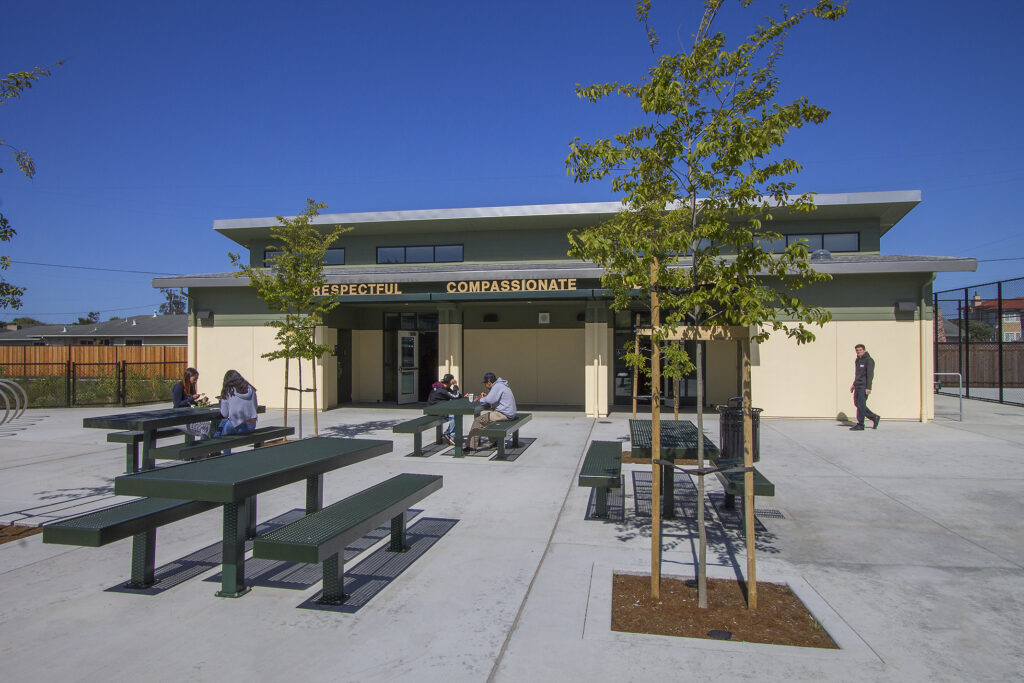 Outdoor seating area at a modern continuing education campus in California, showcasing sustainable design and green elements.
