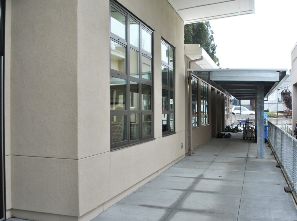 Exterior of modular classroom building at Roosevelt Elementary School, featuring large windows and a covered walkway.