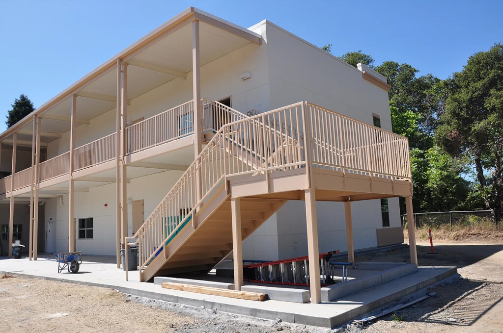 Side view of the two-story modular classroom building at Soquel Elementary School under construction, featuring stairs and walkways.