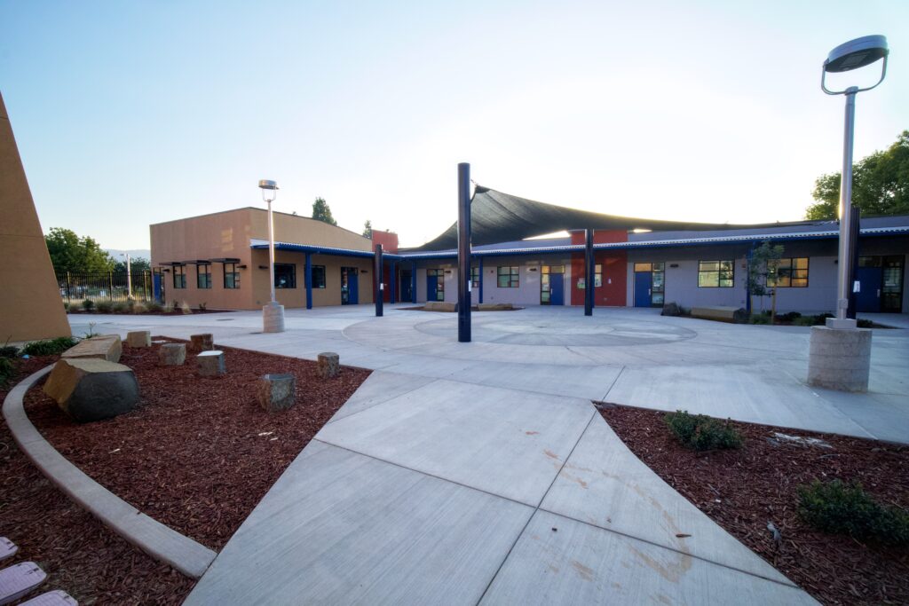 Courtyard view of Hart Middle School's modular science building, with modern architecture and outdoor learning spaces.