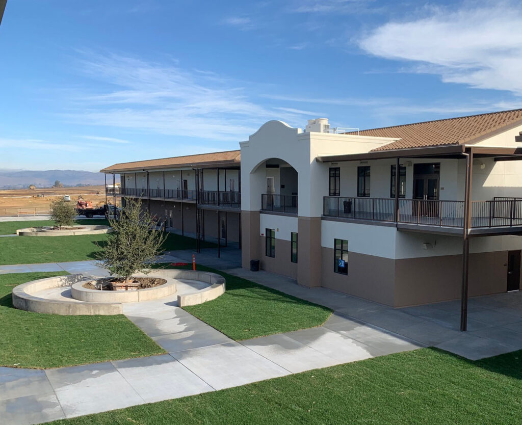 Aerial view of Rancho Santana School’s courtyard, showcasing the modern two-story modular buildings and central landscaping.