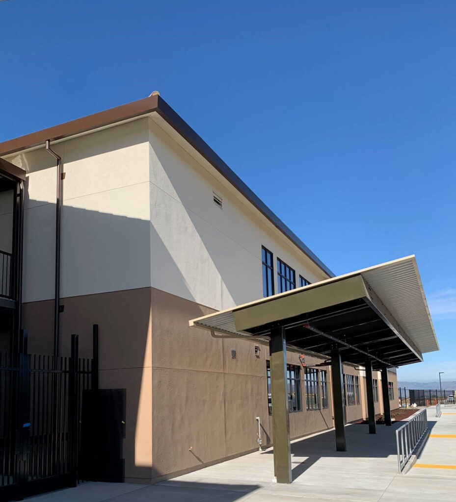 Covered walkway at Rancho Santana School with a view of the modular buildings and outdoor area.