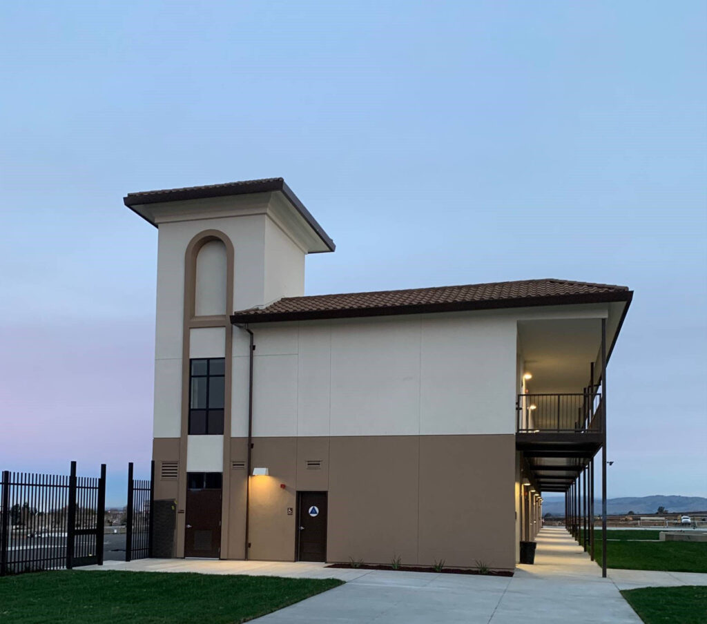 Rear entrance of the Rancho Santana School modular building with a modern architectural design and walkways.