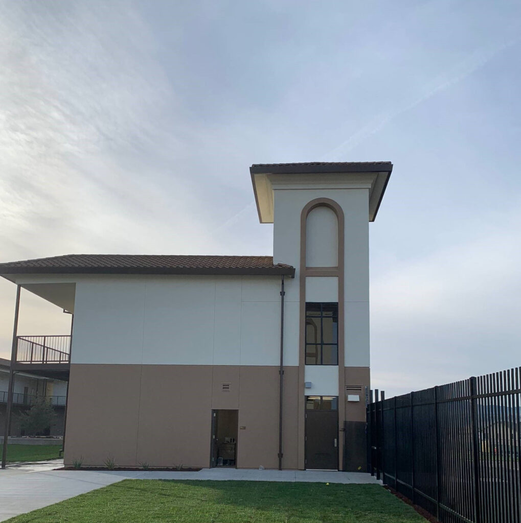 A tower entrance at Rancho Santana School, featuring modern architectural design with modular construction elements.