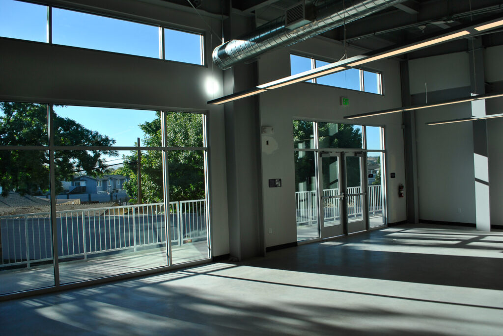 Large windows and glass doors in the hallway of Rocketship Senter Road Campus, offering natural light.