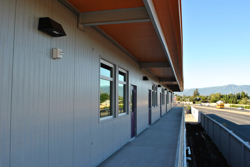 View along the upper balcony and hallway of the Rocketship Senter Road Campus two-story building.