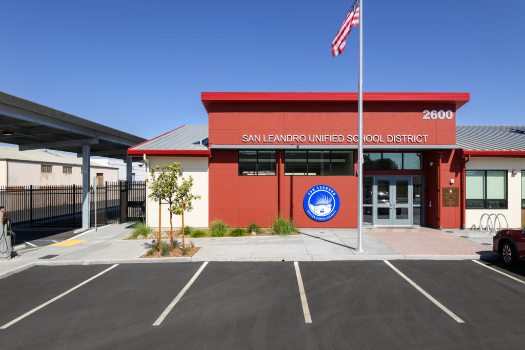 The striking front facade of the San Leandro USD headquarters, featuring bold architectural colors and modern modular elements.