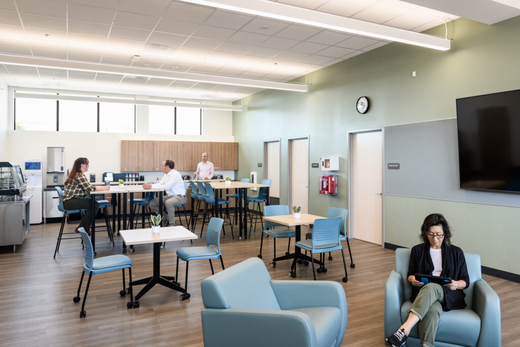 The modular structure at the San Leandro USD District Office site features integrated staircases and expansive outdoor walkways.